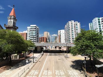 View of city street and buildings against sky