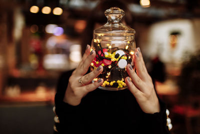 Midsection of woman holding christmas decoration