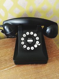 Close-up of rotary phone on table