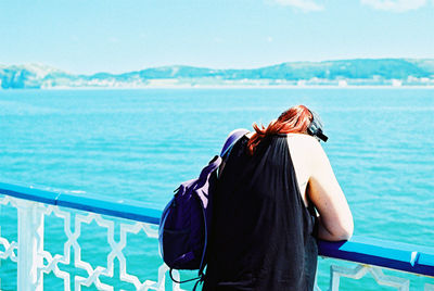 Rear view of woman looking at swimming pool