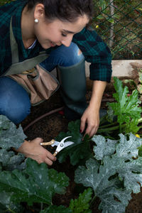 Rear view of boy looking at plants