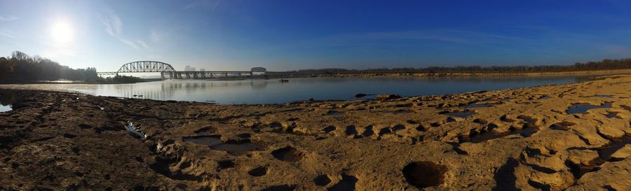 Panoramic shot of bridge over water against sky