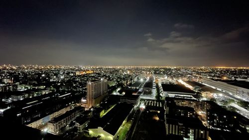 High angle view of illuminated buildings in city at night