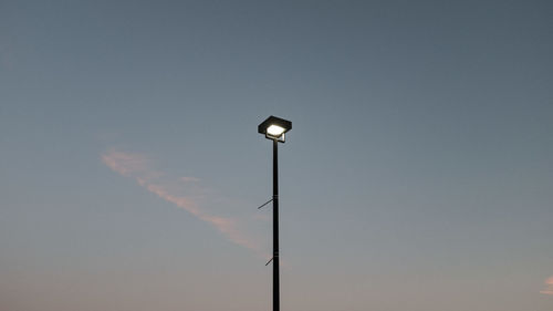 Low angle view of illuminated street light against sky