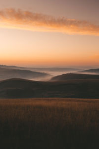 Scenic view of field against sky during sunset