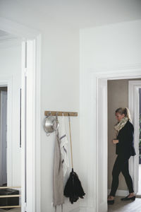 Side view of businesswoman seen through doorway at home