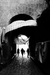 Rear view of people walking in corridor of building