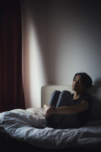 Pensive man sitting on sofa