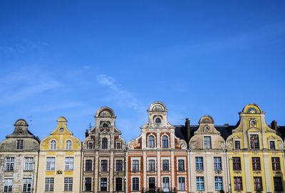 Low angle view of building against blue sky