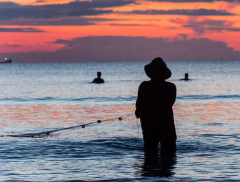 A fisherman is fishing at sunset on koh rong, cambodia