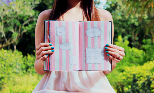 Cropped image of woman holding cigarette