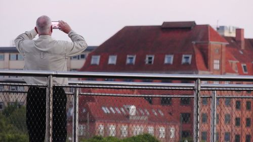 Low angle view of man standing against building