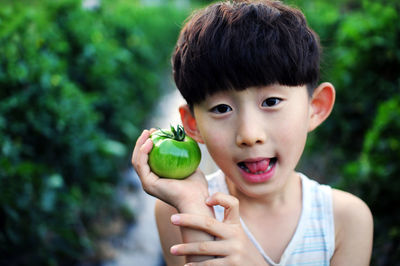 Portrait of boy holding apple