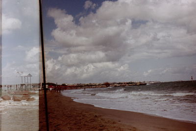 Scenic view of sea against cloudy sky