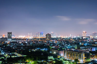 High angle view of illuminated city buildings against sky