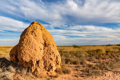 Hay bales on field against sky