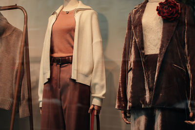 Fashion details of a white cardigan, brown velvet jacket and pants. casual women's fashion cloth