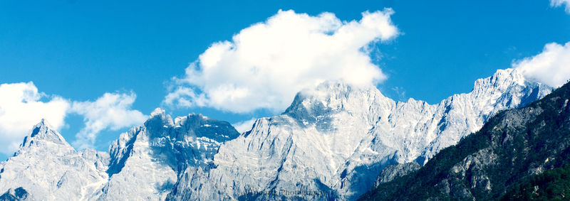 Panoramic view of snowcapped mountains against sky