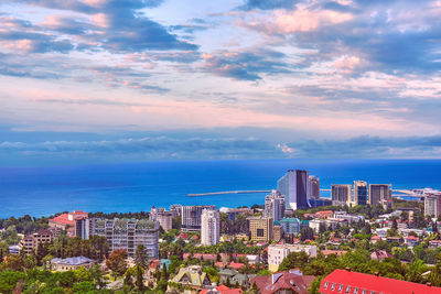 High angle view of buildings and sea against sky