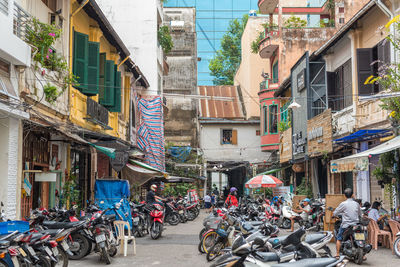 People on street amidst buildings in city