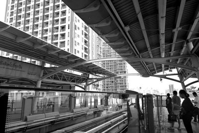 People at railroad station in city