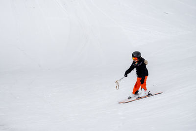 Full length of girl skiing on snow