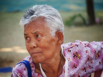 Close-up portrait of woman against blurred background