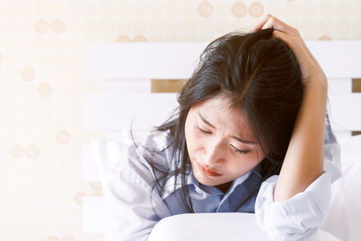 Young lazy woman relaxing on bed