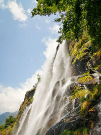 Scenic view of waterfall against sky