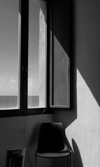 Empty chair by window at home