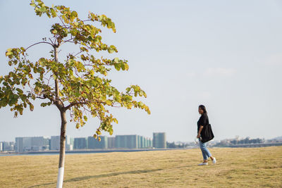 Full length of man walking on field against sky