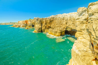 Scenic view of sea against clear blue sky