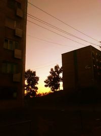 Low angle view of built structure against sky at sunset