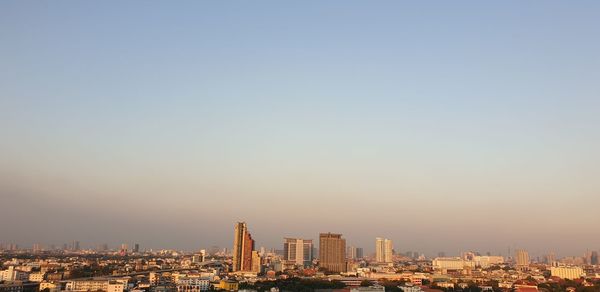 Modern buildings in city against clear sky