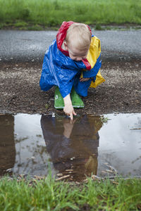Boy playing in the puddle