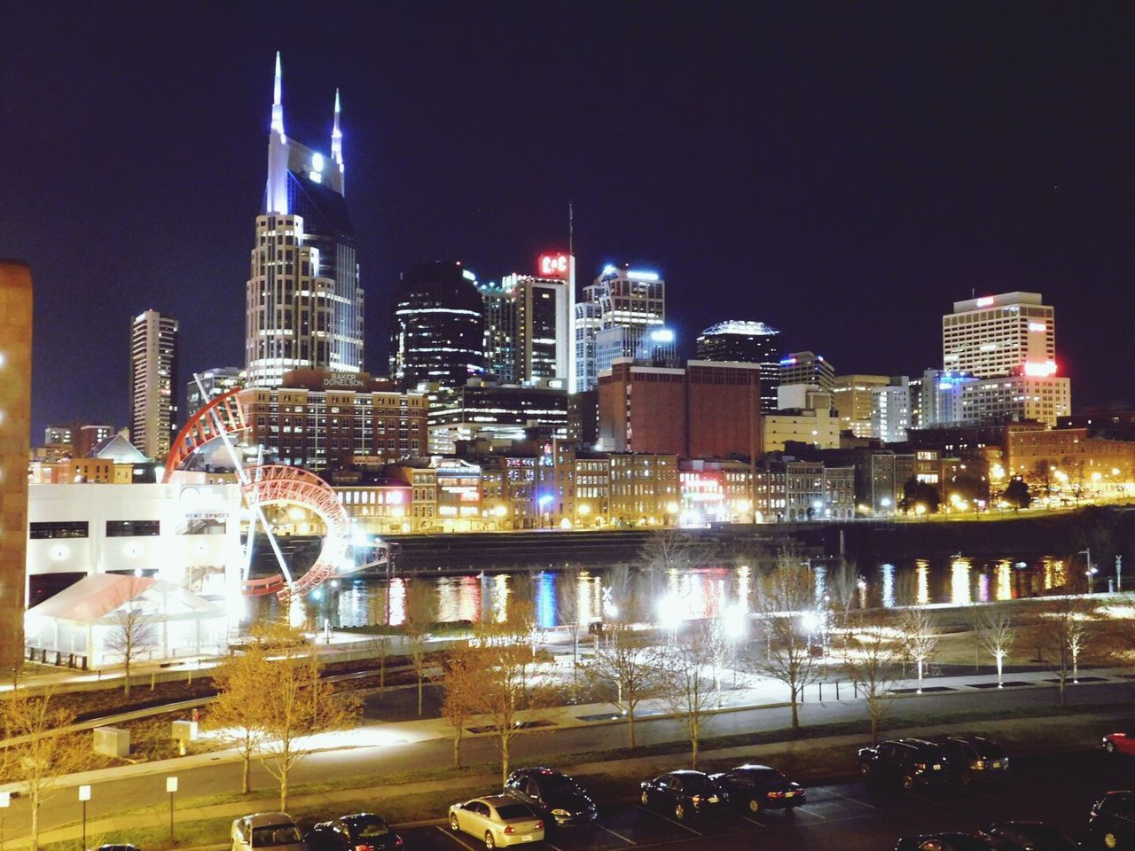 night, illuminated, architecture, city, skyscraper, building exterior, reflection, urban skyline, cityscape, modern, tower, downtown district, sky, built structure, travel destinations, outdoors, office building exterior, no people, futuristic