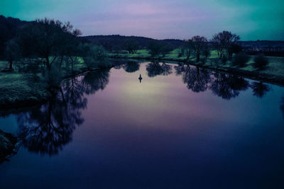 Reflection of trees in lake against sky