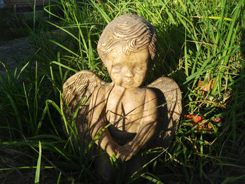 Close-up of angel statue on field