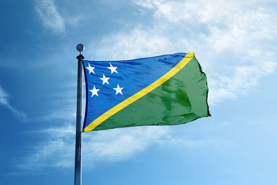 Low angle view of flag against sky