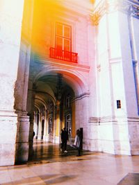 People walking in corridor of building