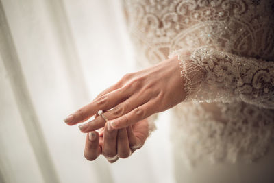 Midsection of bride wearing ring during wedding ceremony