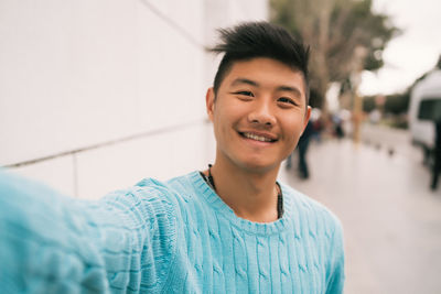 Portrait of smiling young man standing outdoors