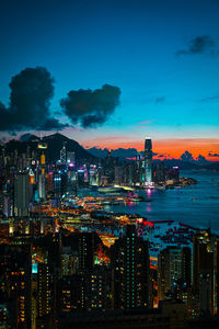 Illuminated buildings in city against sky at night