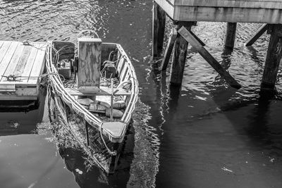 High angle view of boat moored on sea by pier