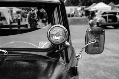 Close-up of vintage car on road