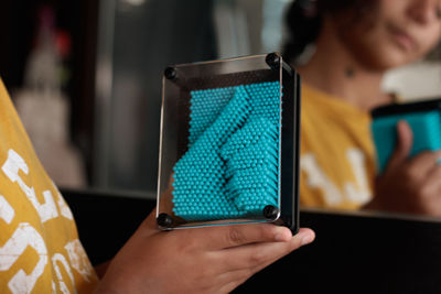 Close-up of woman using mobile phone at home