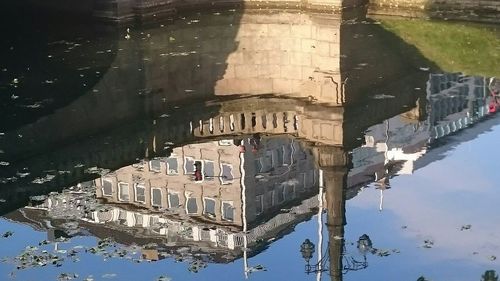 Building reflecting in water