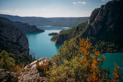 High angle view of lake and mountains against sky