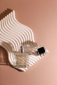 Close-up of perfume on colored background