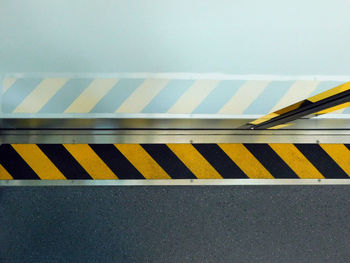 Close-up of yellow umbrella on road